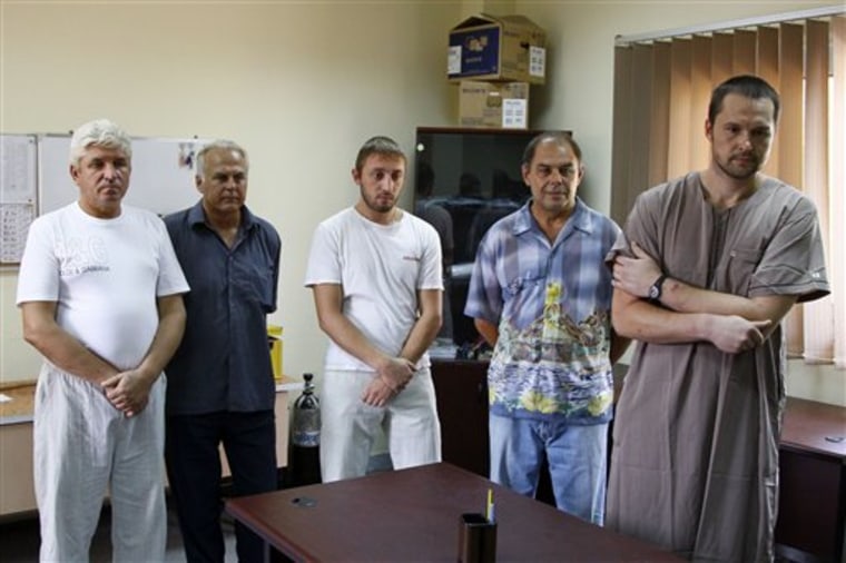 Ukrainians living in Libya and suspected of being mercenaries for Moammar Gadhafi are detained in a Libyan military base held by rebels from the Zentan Al Kakaa Brigade, in Tripoli, Libya, Saturday, Sept. 3, 2011. They're among thousands of foreigners caught in a web of suspicion as rebel fighters pursue the remnants of Gadhafi's forces. 
